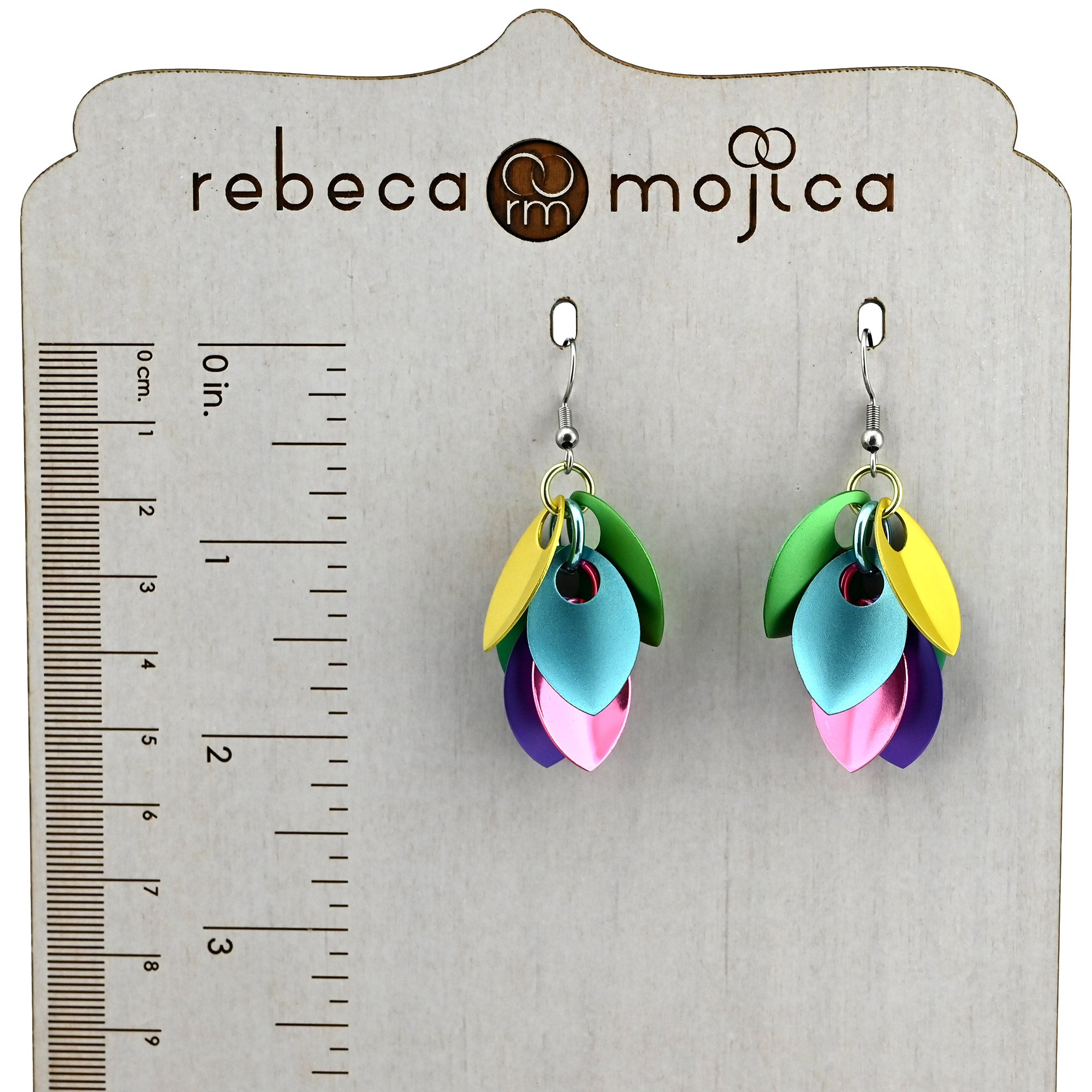 Scalemaille pastel earrings on a branded display with a ruler, showing the earrings measure approximately 2 inches from the top of the stainless steel earwire.