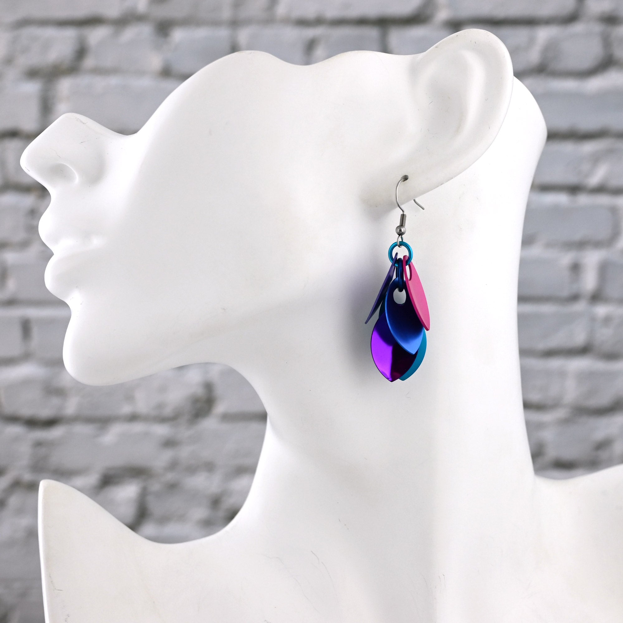 Side view of a white mannequin wearing one Magical Butterfly earring, showing the 2-inch drop resting just below the jawline.