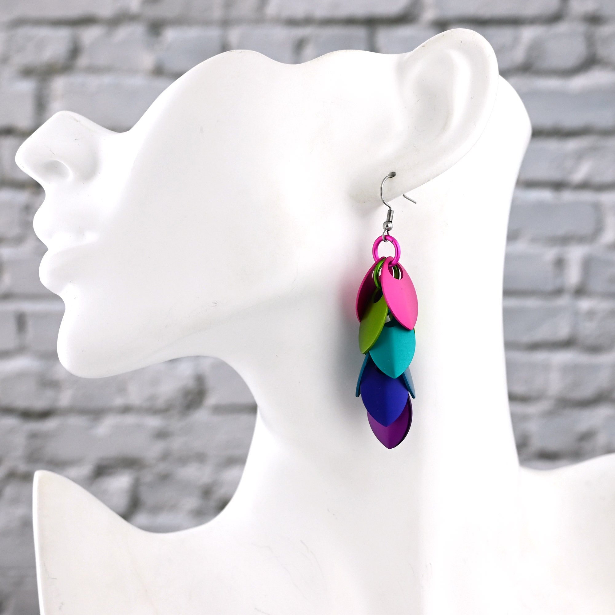 Side view of a white mannequin wearing the long Electric Rainbow dangles, showing the 3-inch drop reaching mid-neck.