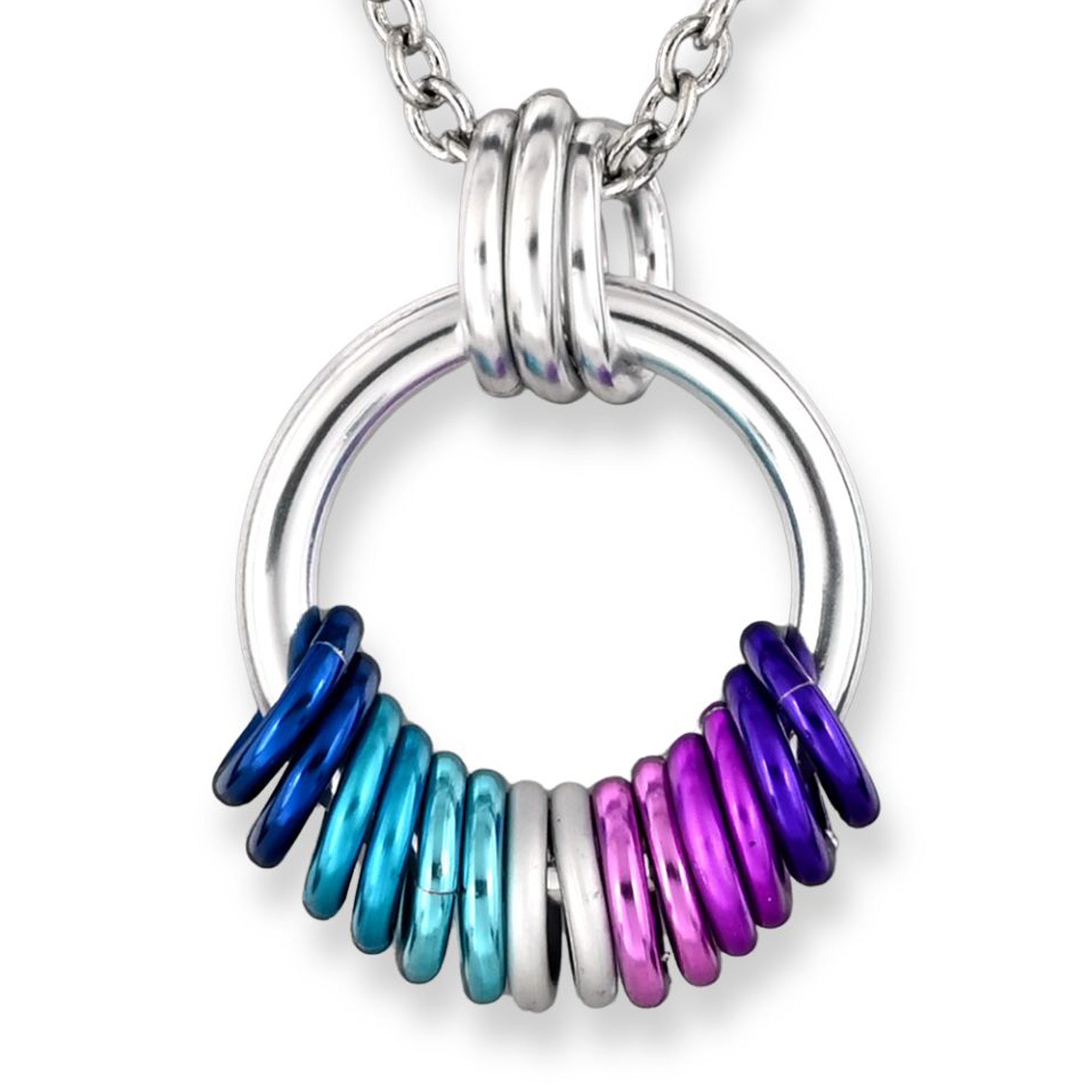 Closeup of a silver hoop chainmaille pendant featuring aluminum rings in the Berrisexual flag colors: shades of blue, teal, white, lilac and purple. The rings sit in a tight, tactile coil.