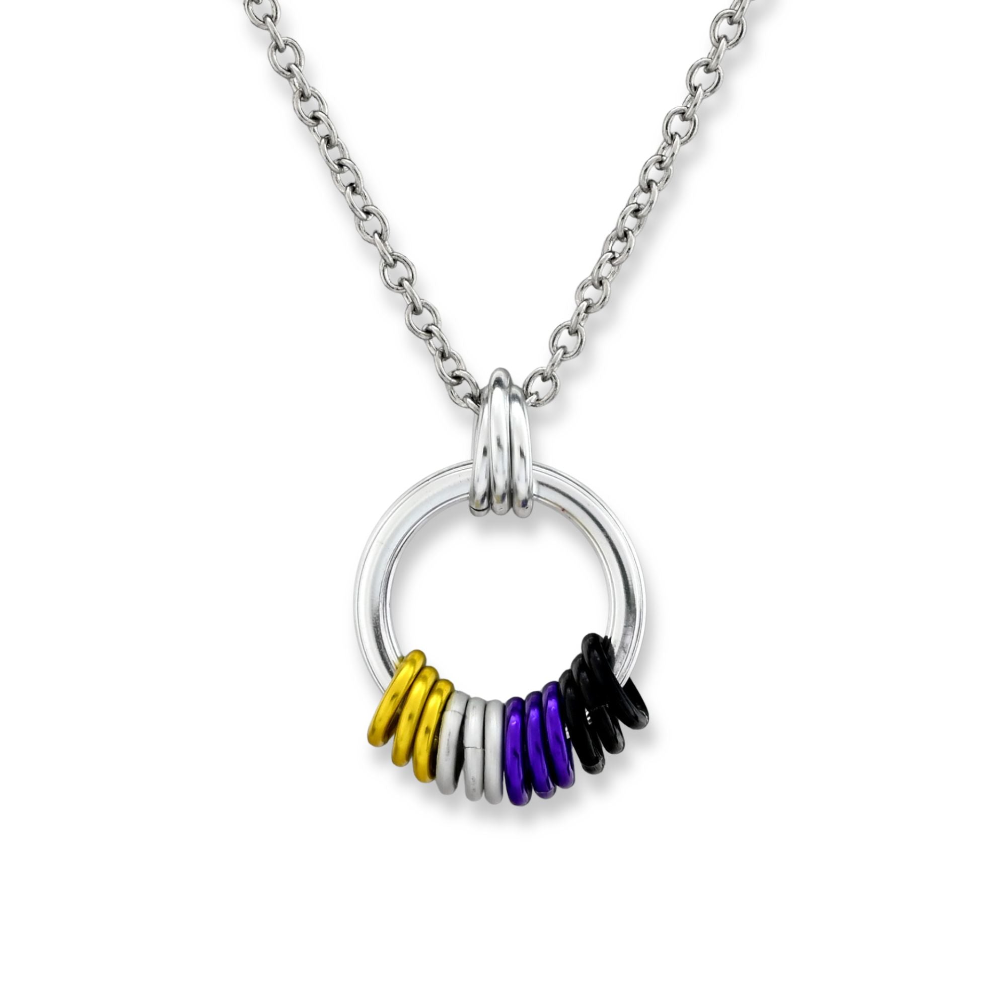 A silver circular pendant on a white background featuring a cluster of rings in the Nonbinary (Enby) Pride flag colors: yellow, white, purple, and black.