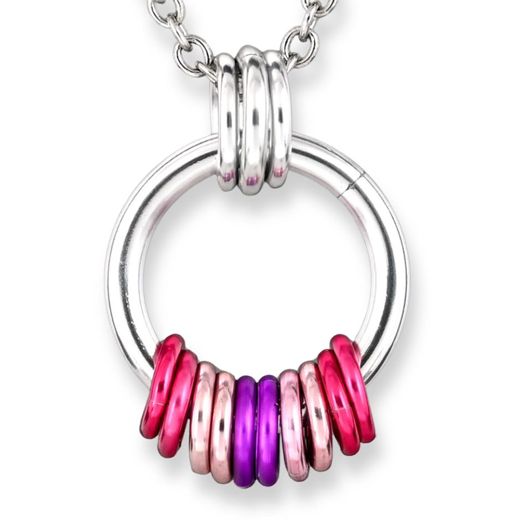 A silver circular chainmaille pendant with free-spinning rings in the Sapphic flag colors: dark pink, light pink, white, and purple. The vibrant rings are clustered at the base of the silver hoop and displayed against a plain white background