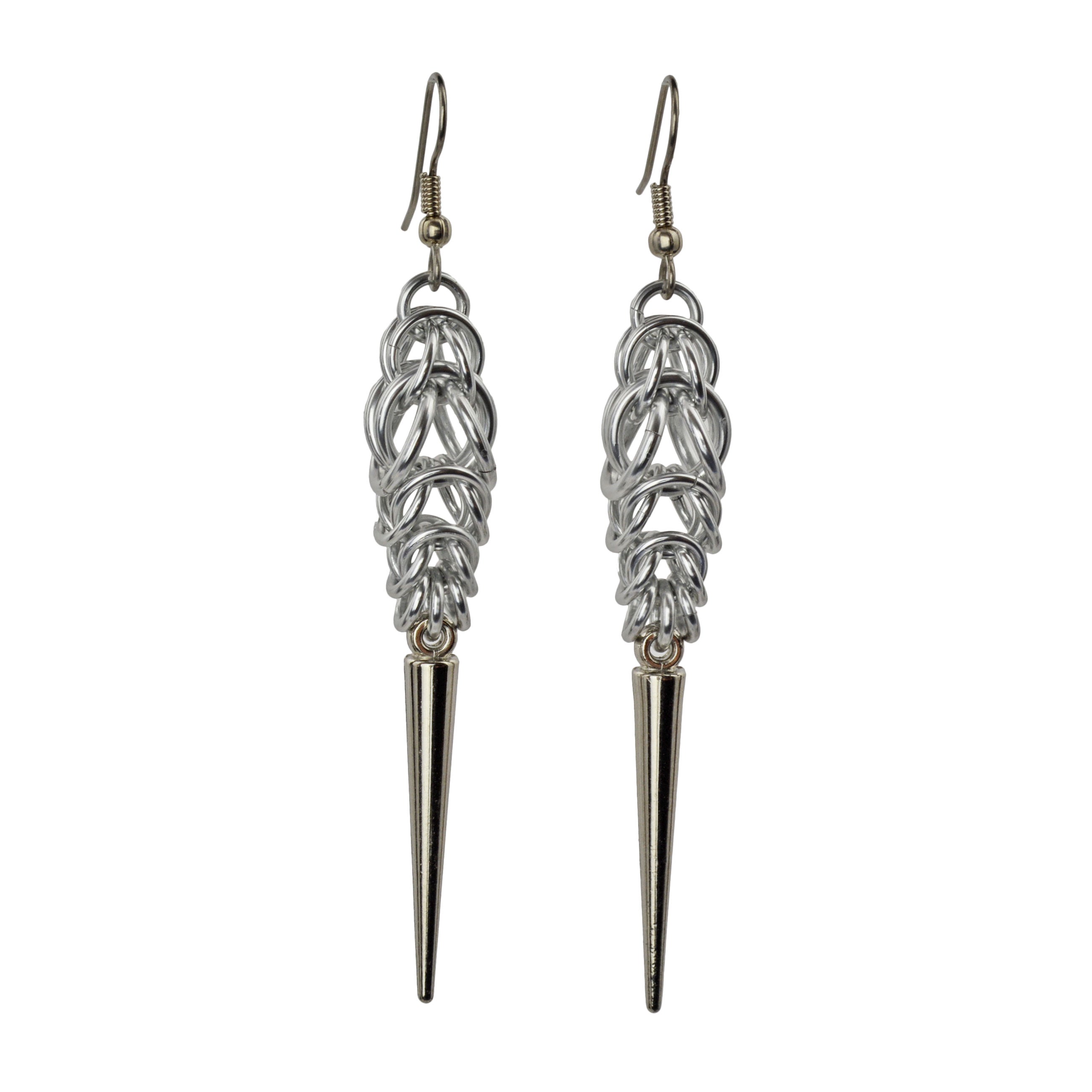 Long, silver color chainmaille earrings in a drop shape, with a long silver spike at the base. The earrings are Persian 6-in-1 weave at the top, transitioning to Box Weave.