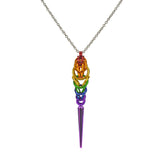Chainmaille pendant in LGBTQ rainbow colors hanging from a thin steel chain on a white background. Pendant is made in the Rainbow Pride flag colors: red, orange, yellow, green, blue and violet, with a lilac spike at the base. Chainmaille weave is Full Persian 6-in-1 at the top and Box weave at the bottom.