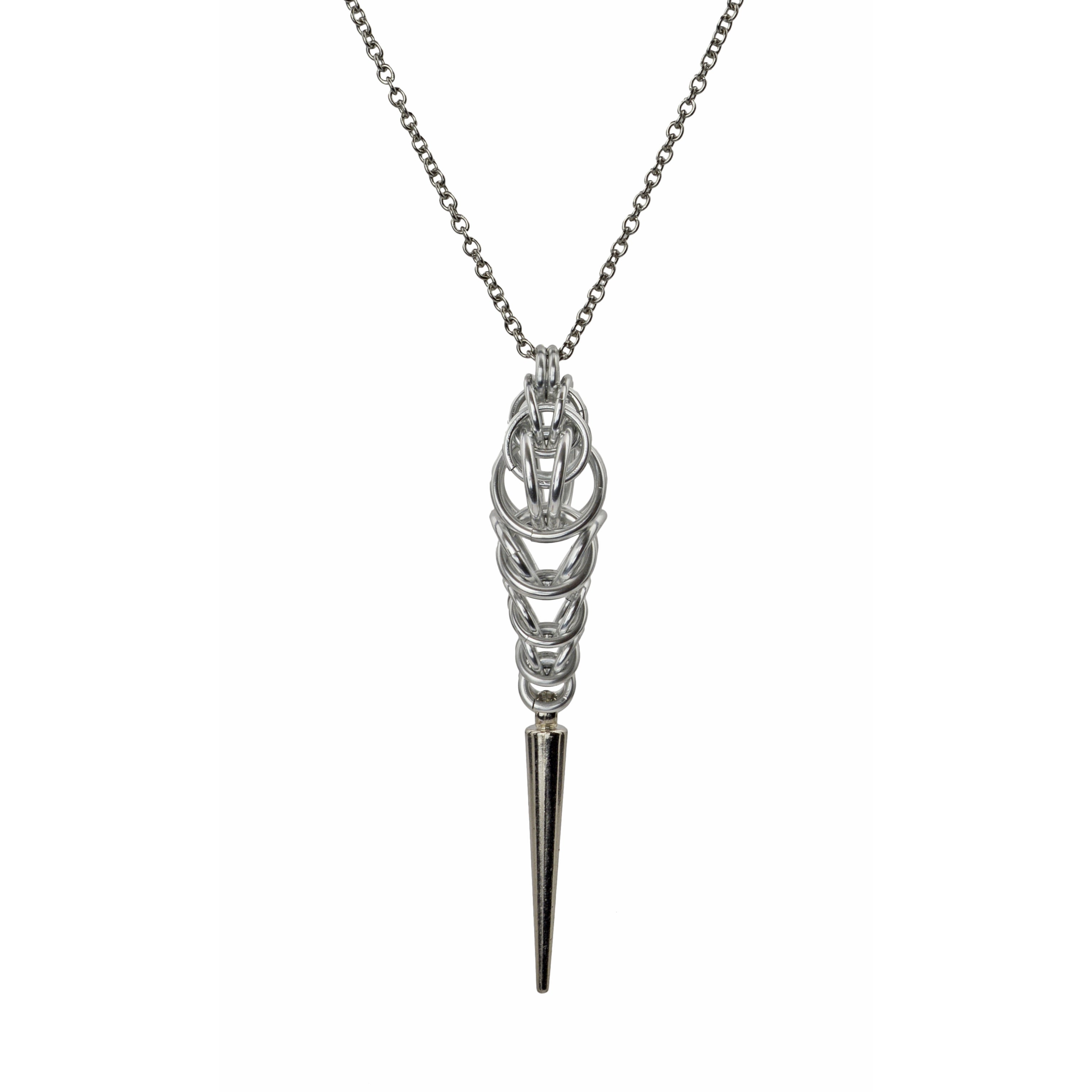 Chainmaille pendant in pastel colors with spike at the bottom on a white background. Pendant uses silver color rings in a Persian-variation weave at top, transitioning to box weave, and finishing with a long spike at the base.