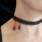 Closeup of neck with black color chainmaille mesh band and two deep red drops meant to look like blood trickles. The red drops are positioned on the side of the neck, to allude to a vampire bite.