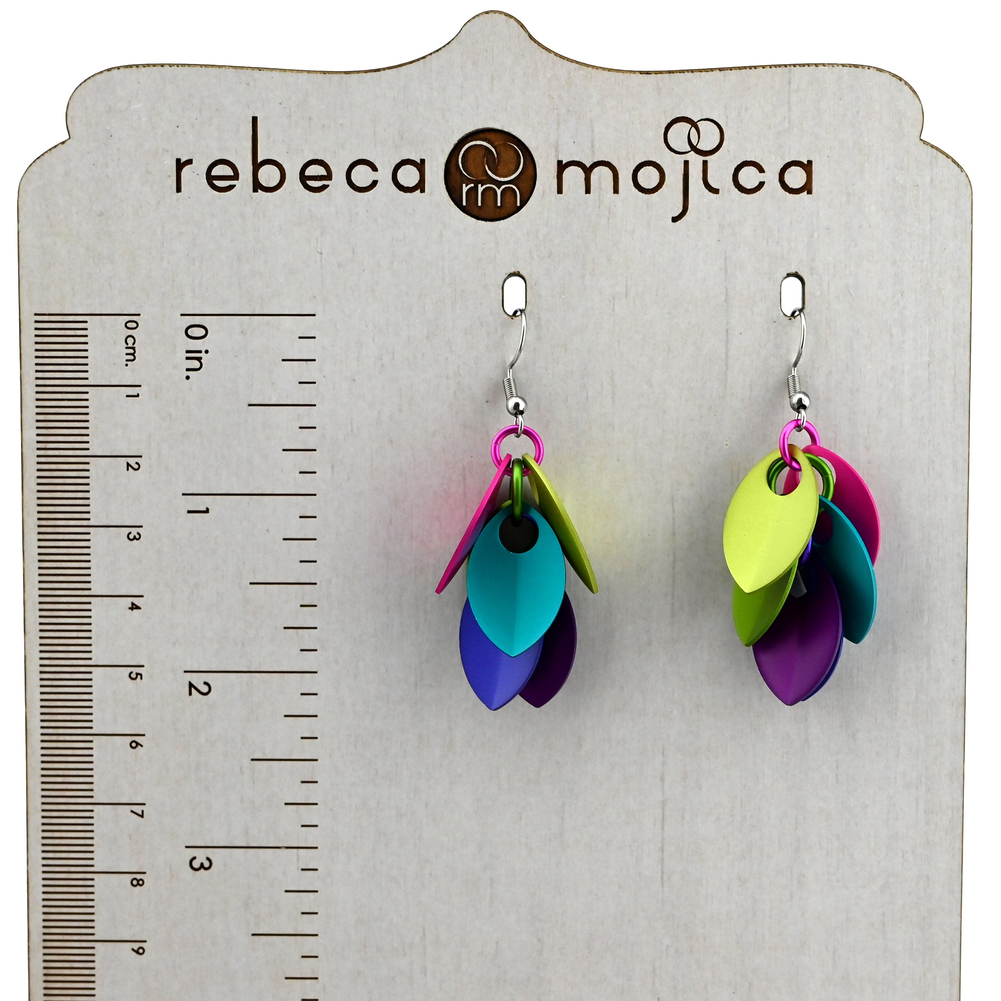 Electric Rainbow scalemaille earrings shown on a branded display with a ruler, measuring approximately 2.25 inches in length.