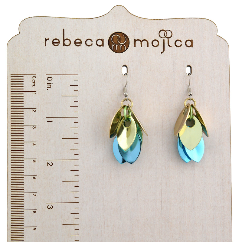 Dangle earrings next to a ruler, measuring approximately 2 inches to illustrate the size and scale.