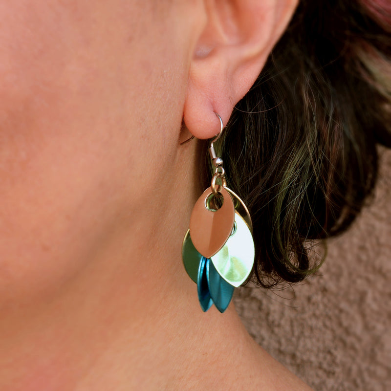 Close-up of Rebeca Mojica wearing the seashell ombre dangle earrings, focusing on how they look on the ear and the gentle curve of the design.
