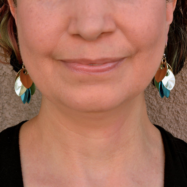 Rebeca Mojica wearing the lightweight aluminum dangle earrings, showcasing how they move and catch the light.
