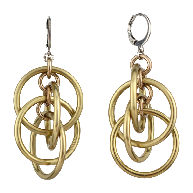 Product photo of champagne-colored intertwined hoop chainmaille earrings with round leverback ear wires, isolated on a white background.