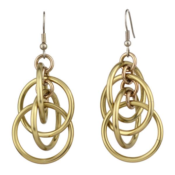 Product shot of champagne-colored intertwined hoop chainmaille earrings with standard fishhook ear wires, isolated against a white background.