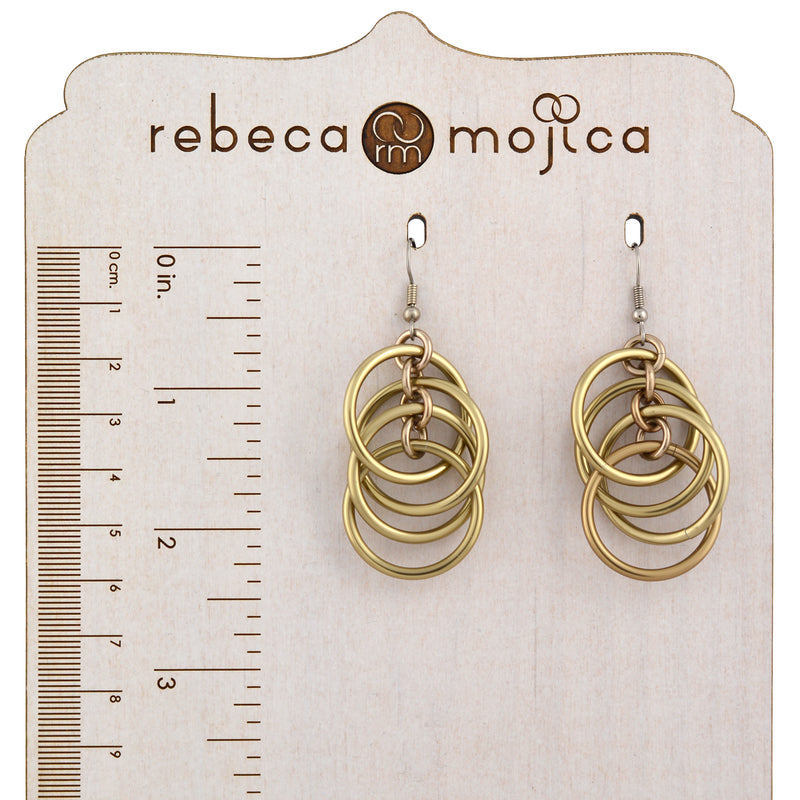 Champagne-colored intertwined hoop chainmaille earrings on a branded wooden earring card with a ruler, showing their length is approximately 2.5 inches (6.5 cm).