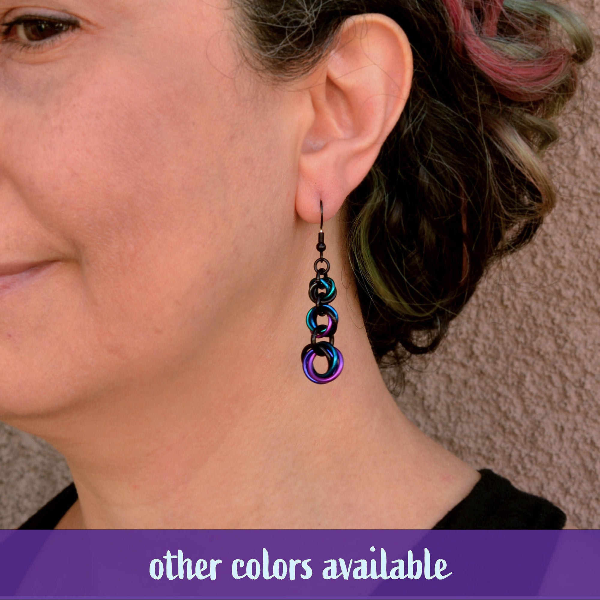 A person wearing a similar graduated knot style in a teal and blue ombre to demonstrate the fit and movement of the design.