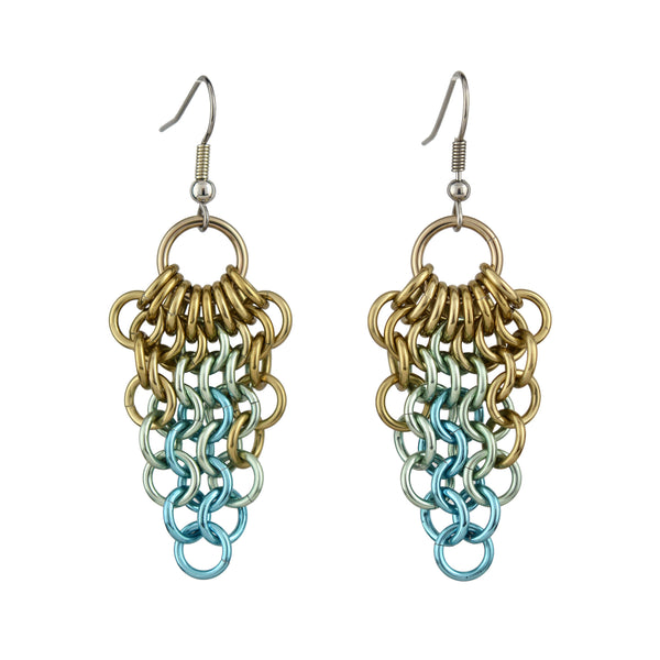 A pair of seashell color teardrop mesh earrings are photographed on a clean white background. The image isolates the earrings, showing the details of the champagne, seafoam, and light blue chainmaille design.
