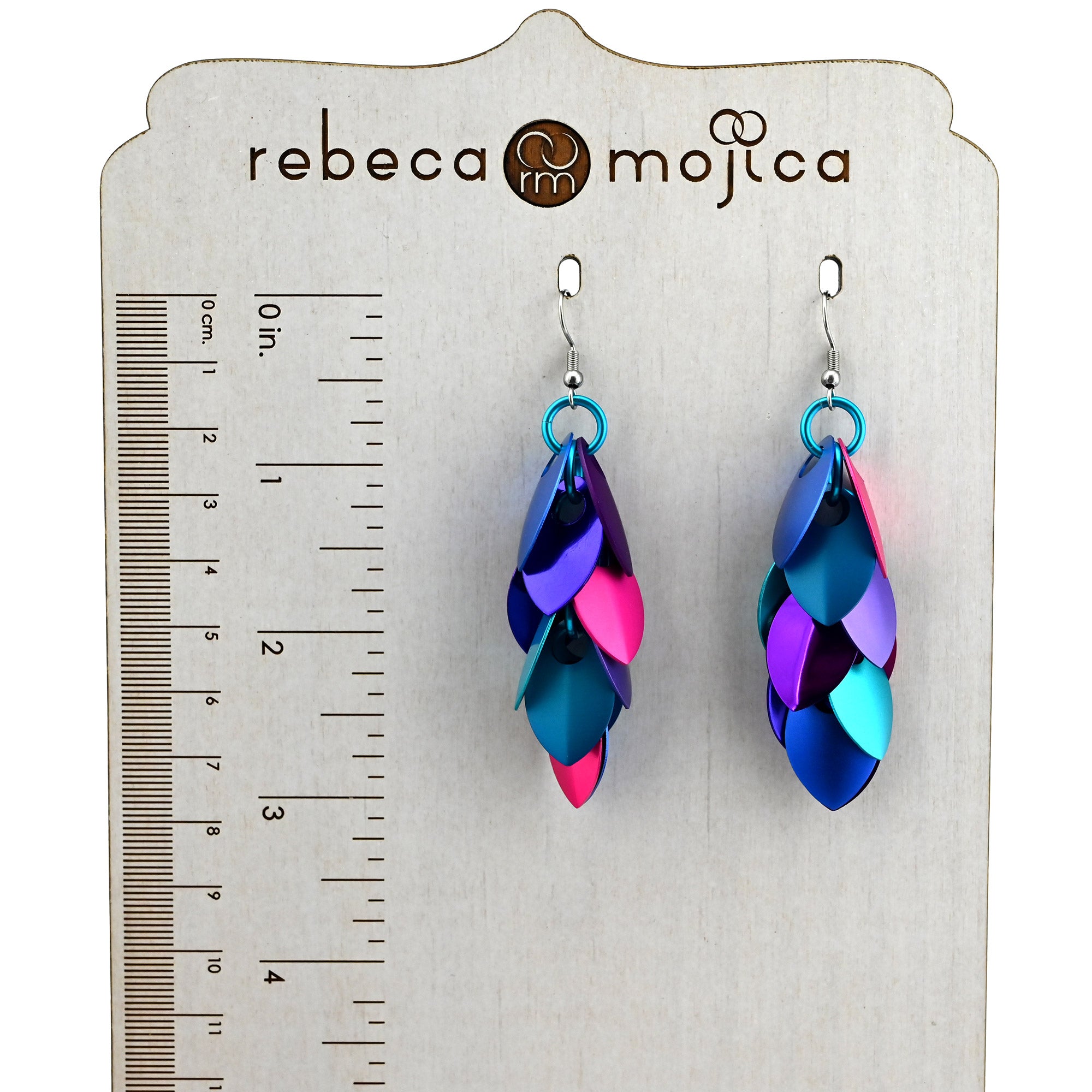 Magical Butterfly Long Feathered Earrings on a branded display stand with a ruler, showing the earrings are approximately 3 inches in length.