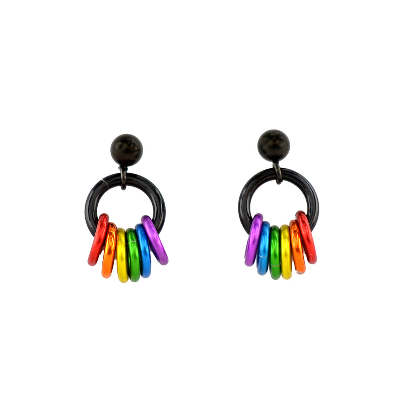 A clean, white background showcases two rainbow pride earrings with black stud posts and black rings. Small rings dangle in the colors of the rainbow pride flag: red, orange, yellow, green, azure, and violet. The colors are mirrored on the earring on the right.