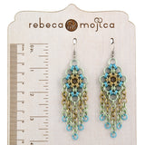 Seashell chandelier chainmaille earrings displayed on a wooden display stand with a ruler alongside to show the 4-inch length.