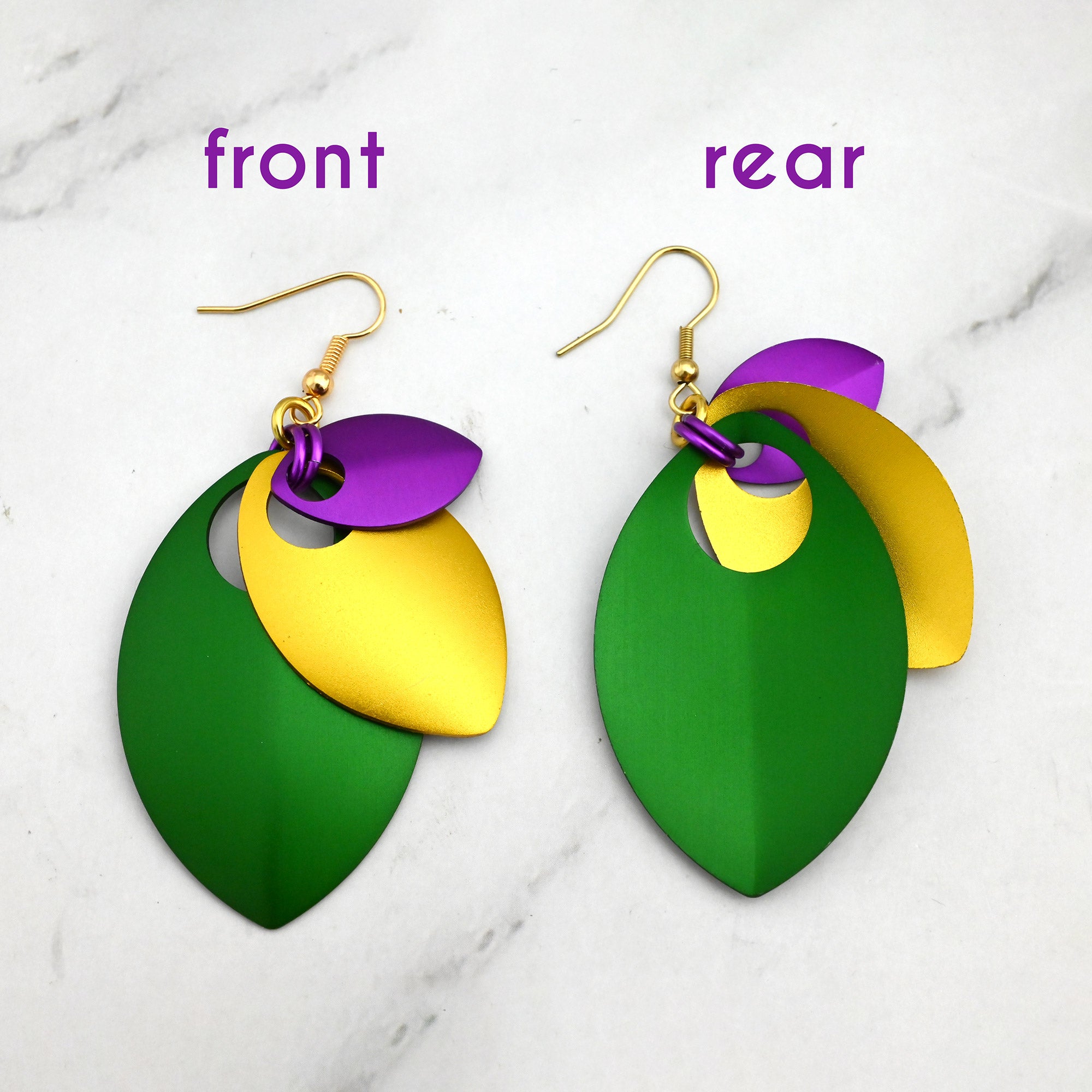 Close-up showing the front and rear views of the stacked leaf earrings to display how the three aluminum leaves are nested together.