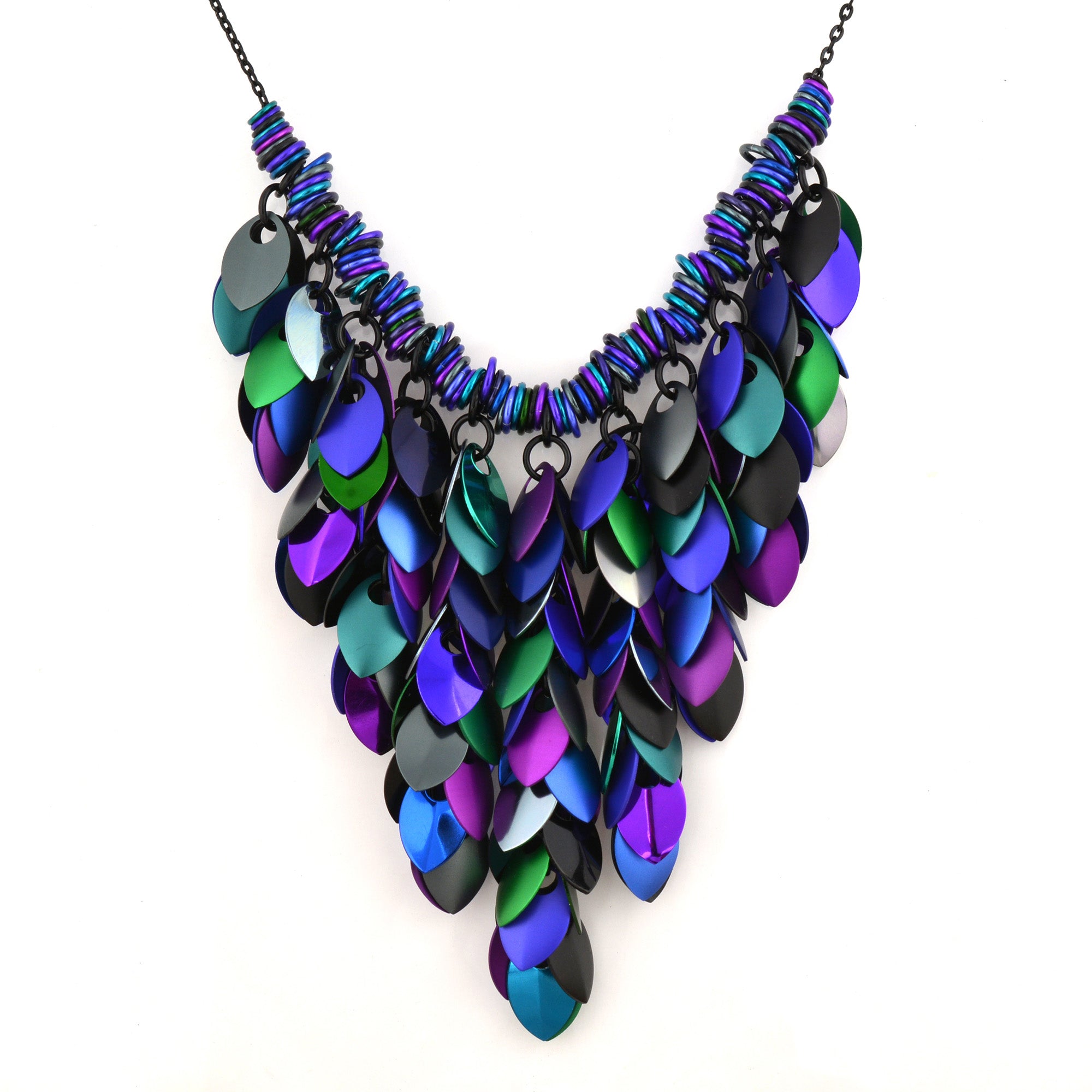 Statement Feathered Bib Necklace in Dark Mermaid colors (purple, blue, green, grey, black). Shows the large, V-shaped scale pattern and iridescent aluminum scalemaille on a white background.