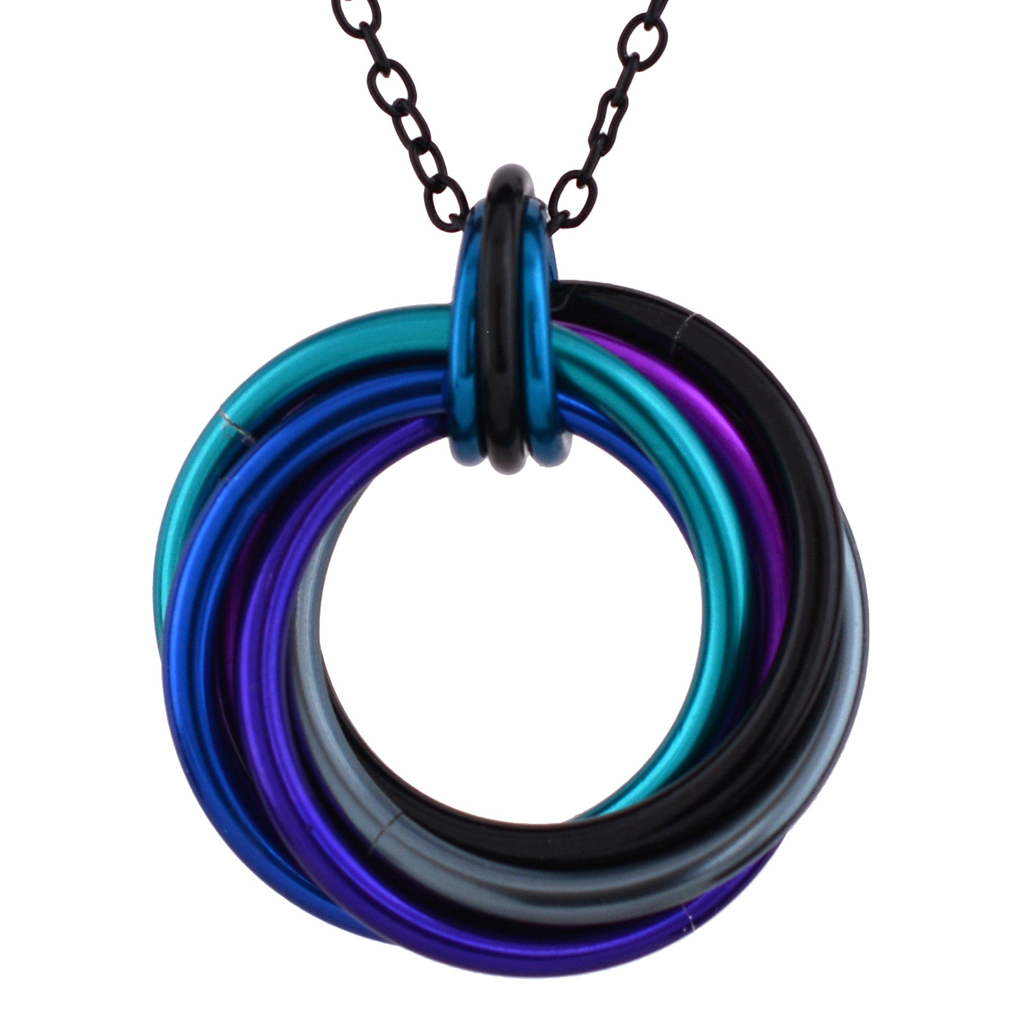 Close-up of the Swirl Pendant featuring black, blue, teal, purple, violet and grey rings on a black chain against a white background.