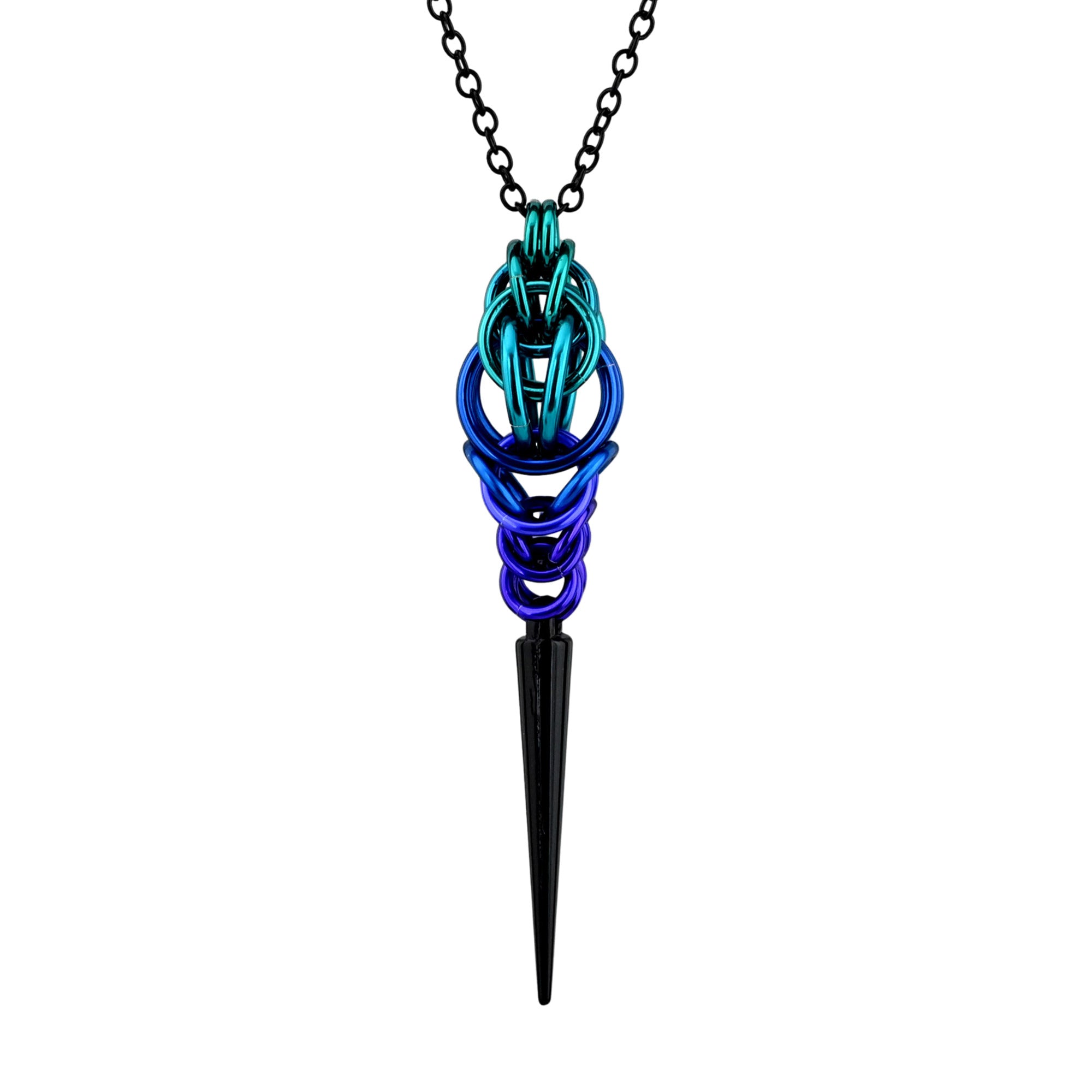 Product shot of a vertical Spike Pendant featuring a chainmail weave transition from teal to blue and purple with a long black spike on a black chain. The pendant is shown against a plain white background.