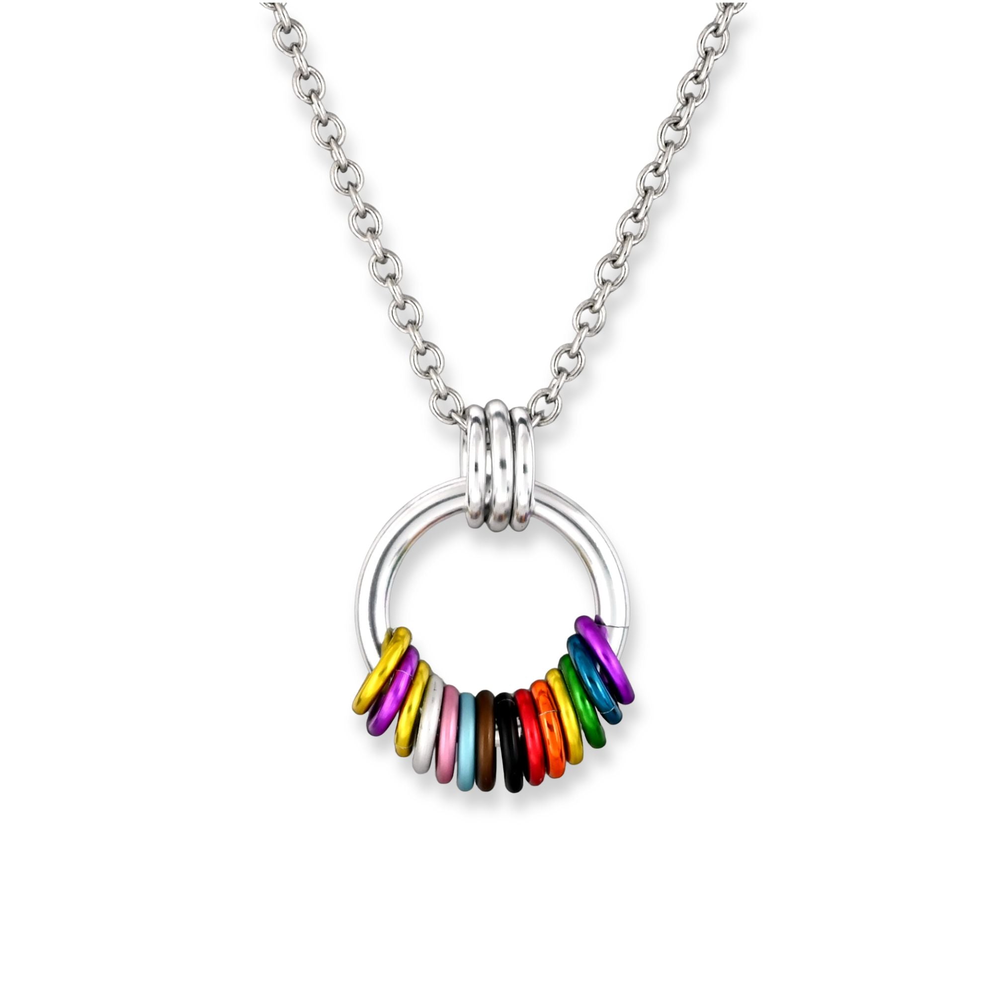 A chainmaille pendant with a coil of free-spinning rings in the intersex-inclusive pride flag colors attached to a larger silver color link. From left to right the colors are yellow, violet, yellow, white, pink, light blue, brown, black and the traditional lgbtq rainbow pride colors. The pendant hangs from a stainless steel link chain against a plain white background.