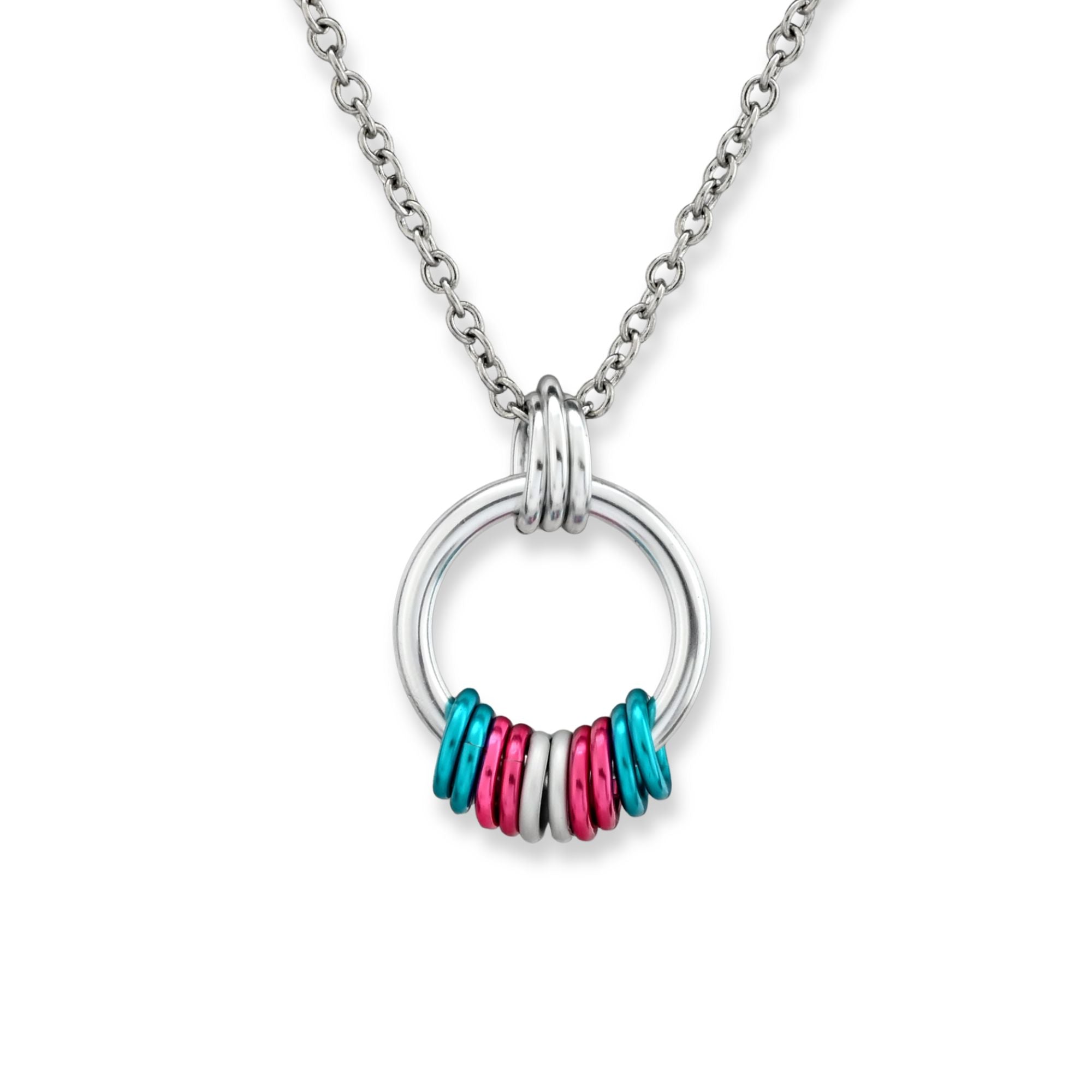 A minimalist silver hoop pendant on a clean white background featuring aluminum rings in the Transgender Pride flag colors: light blue, pink, and white.