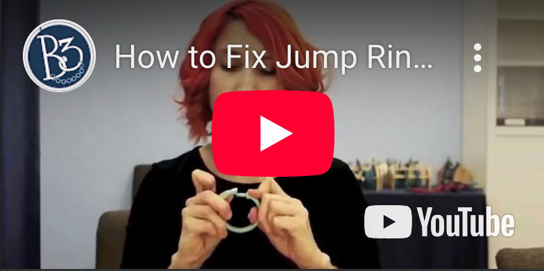  YouTube video thumbnail for the Blue Buddha Boutique channel showing Rebeca Mojica with a shower curtain ring and text How To Fix Jump Rings