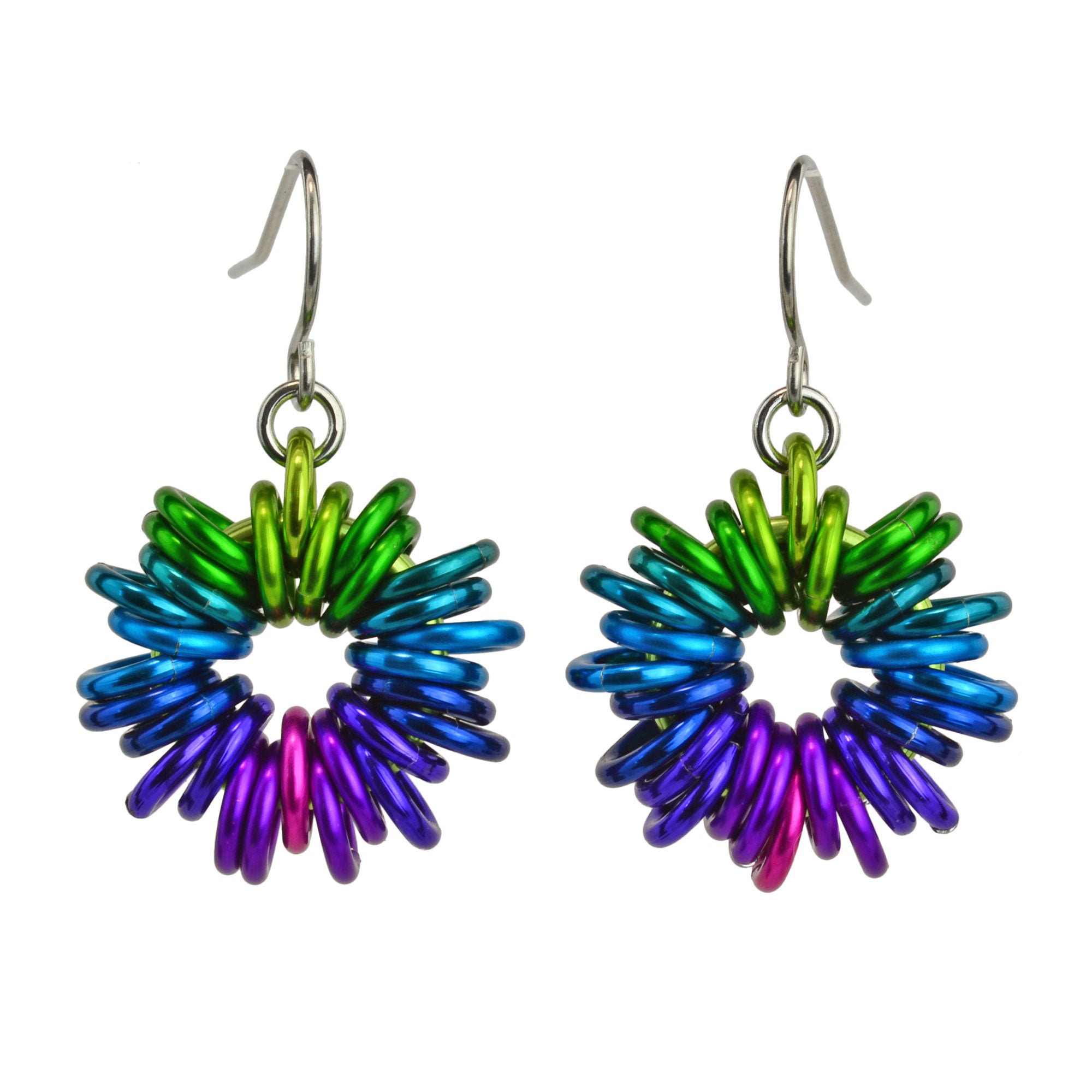 Closeup of rainbow ombre coiled earring by Rebeca Mojica.