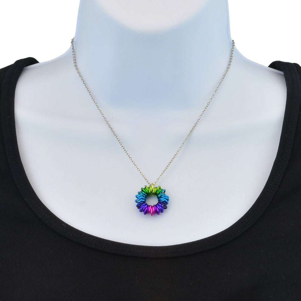 Closeup of Electric Rainbow Coiled Pendant on torso display.