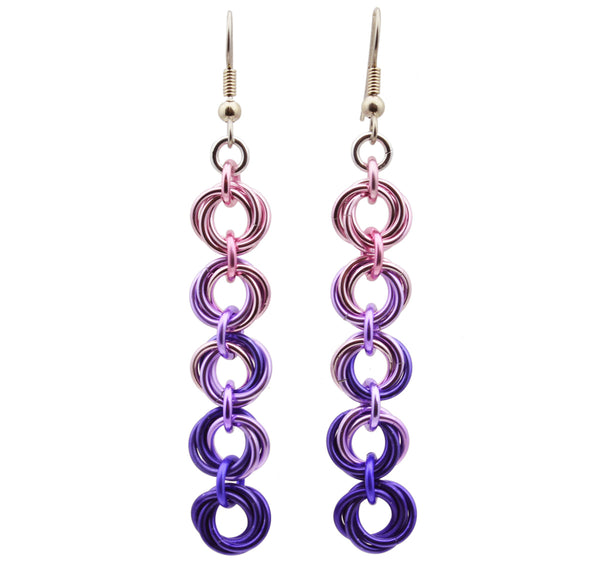 Chainmaille earrings of 5 linked "knots" hanging from the earwire on white background. Top knot is pink transitioning as you move down the earring to lilac and purple.
