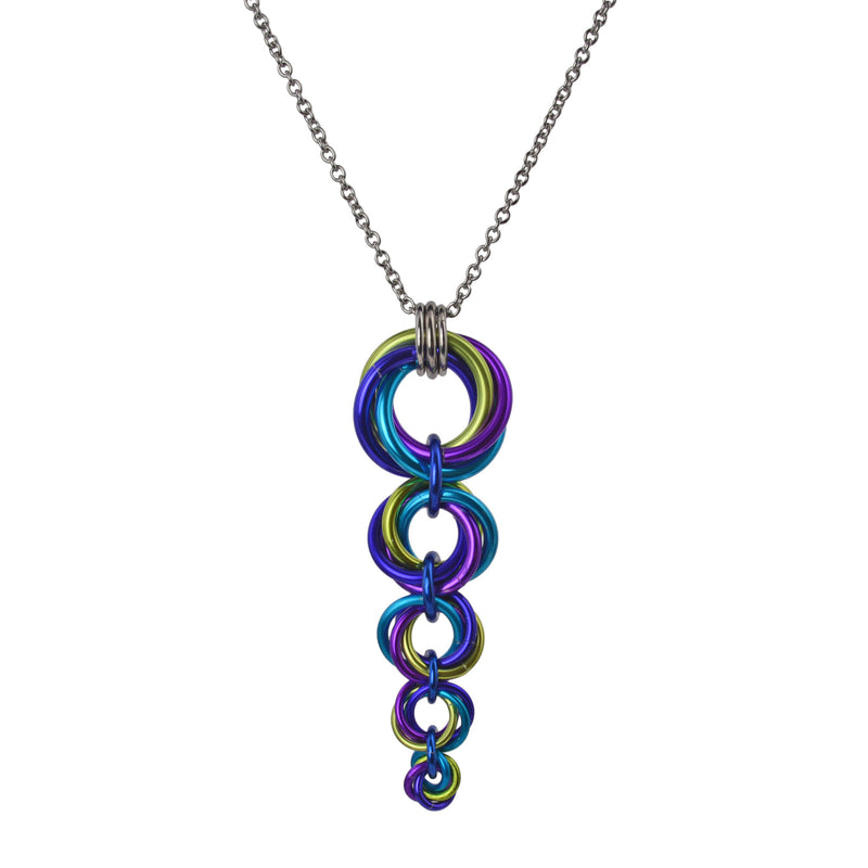 Colorful chainmaille pendant on a white background. The pendant consists of 5 stacked circles, tapering from a large circle at top to a tiny circle at the bottom. Each circle is made of 4 rings: 1 each chartreuse, violet, turquoise and purple.