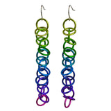 Long earrings made of thin and colorful jump rings. The links are joined in a 1-1-1 chain, with additional loose rings "orbiting" around the main chain. The top color is chartruese, followed by green, teal, blue, purple, violet and bright pink.