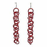 Long red Orbital Earrings by Rebeca Mojica. The earrings are made of thin red jump rings linked together.