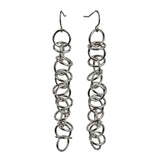 Long Orbital earrings with silver color aluminum jump rings by Rebeca Mojica Jewelry.