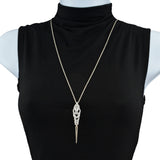 Chainmaille pendant on a stainless steel chain displayed on a torso form with a black turtleneck shirt. The pendant is made of chainmaille and is silver color, with a long silver spike at the base.