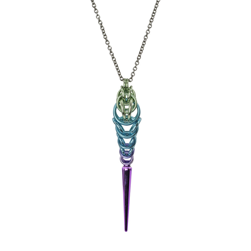 Chainmaille pendant in pastel colors with spike at the bottom on a white background. Pendant is seafoam color at top, transitioning to light blue and finally lilac, with a long lilac spike at the base.
