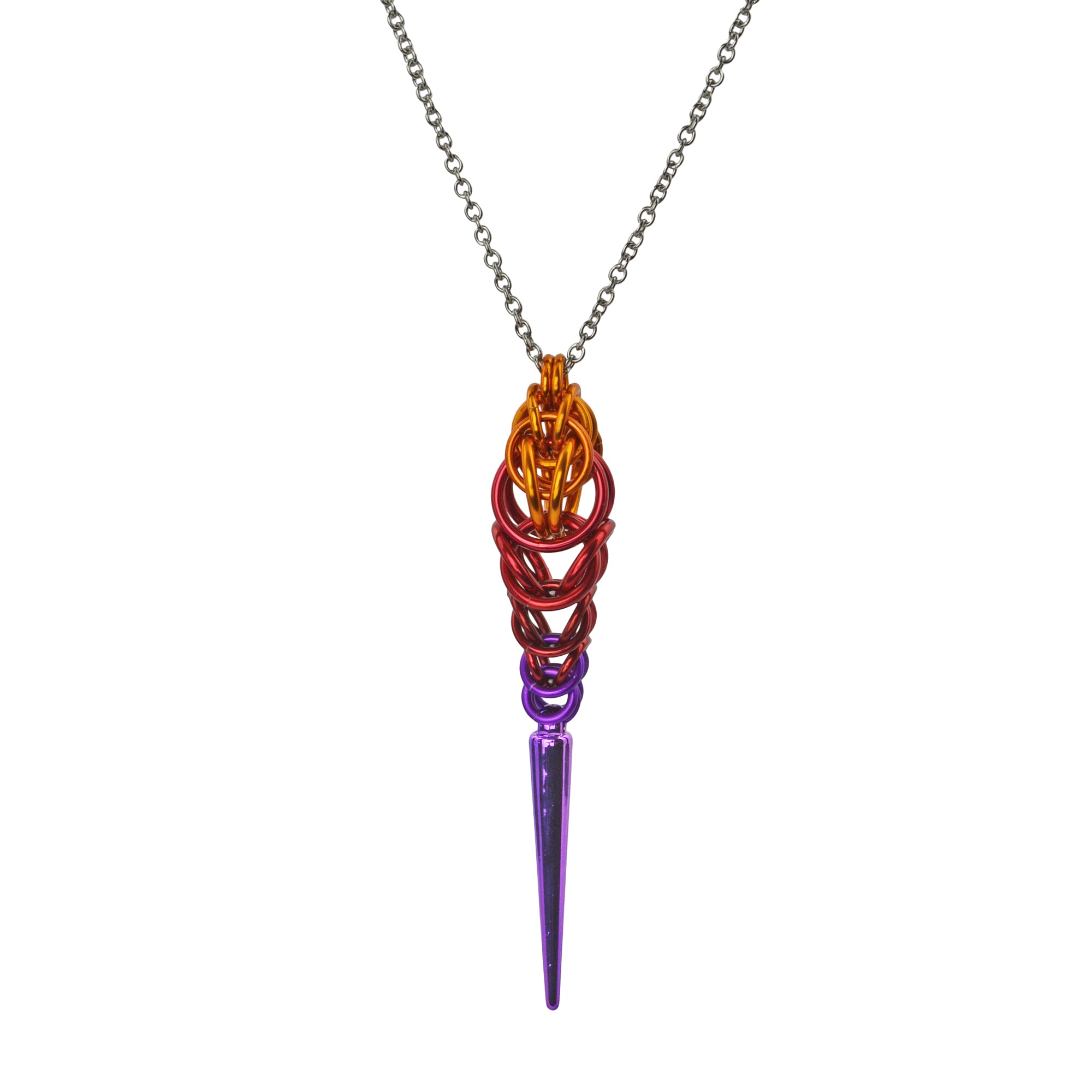 Chainmaille pendant in an ombre with a spike at the bottom on a white background. Pendant is orange color at top, transitioning to red and finally violet, with a long violet spike at the base.