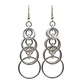 Statement earrings in silver color on a white background. Earrings consist of interlocked hoops that stack and become larger as you move down the earring - the final hoop is 3/4" around