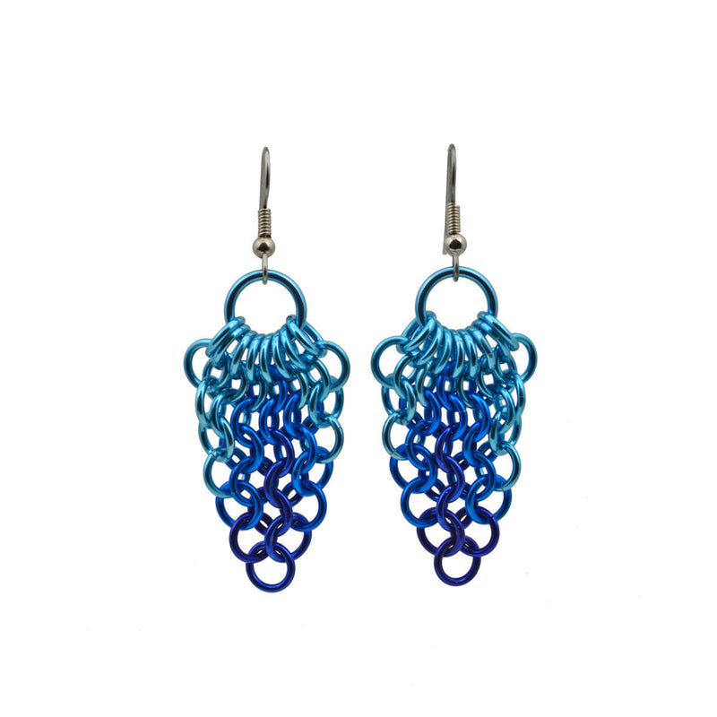 Mesh cluster earrings feature a large light blue jump ring at top, with a mesh hanging and tapering to a point. The upper mesh rings are light blue, transitioning to turquoise and finally dark blue at the bottom tip. The chainmaille pattern is European 4-in-1.